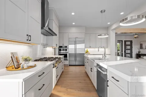 a large kitchen with a large counter top appliances and cabinets