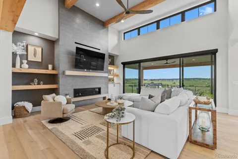 a view of a livingroom with furniture a flat screen tv and kitchen view