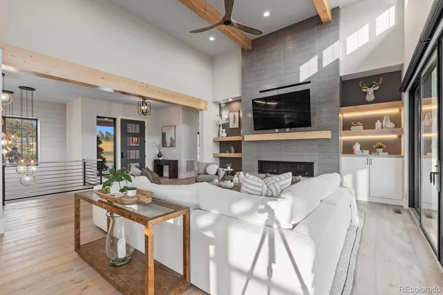 a living room with furniture and view of kitchen