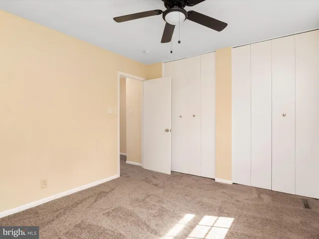 a view of a big room with a ceiling fan