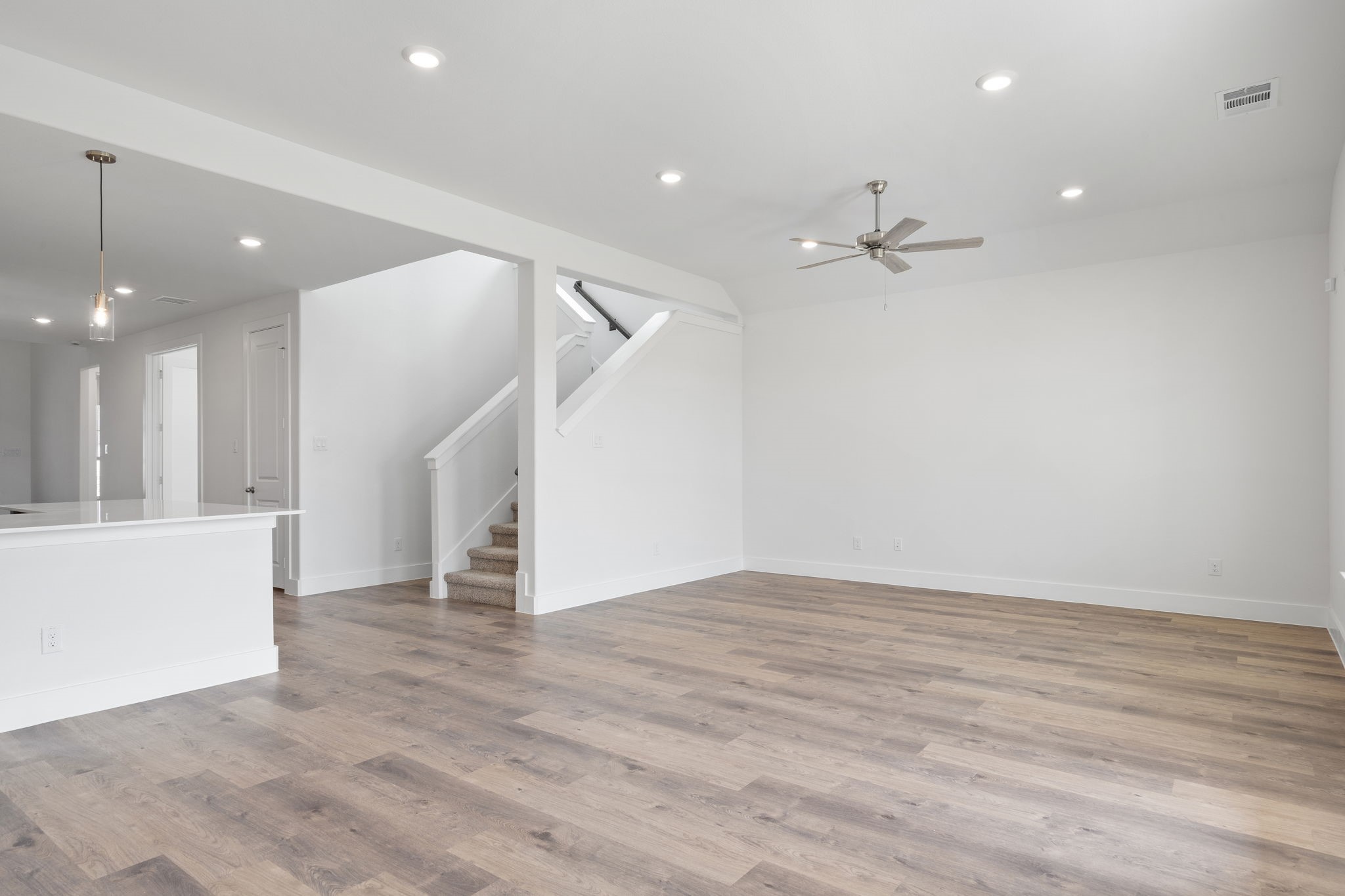 620 Cross Timbers Trace Waller, TX 77484 - Photo 9 of 36 an empty room with wooden floor and staircase