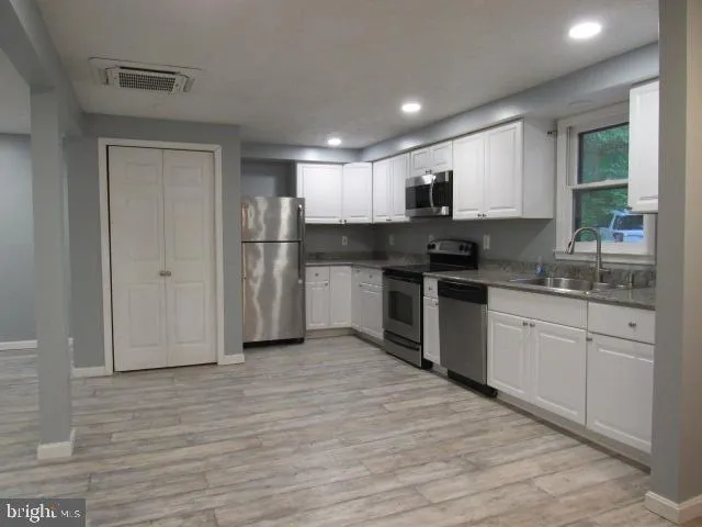 a kitchen with a sink stove and refrigerator