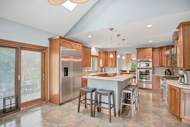 a large kitchen with granite countertop a lot of counter space and a sink