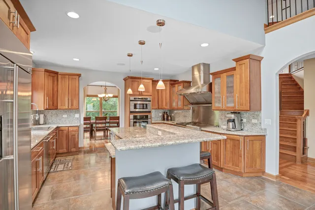 a bathroom with a granite countertop bathtub shower