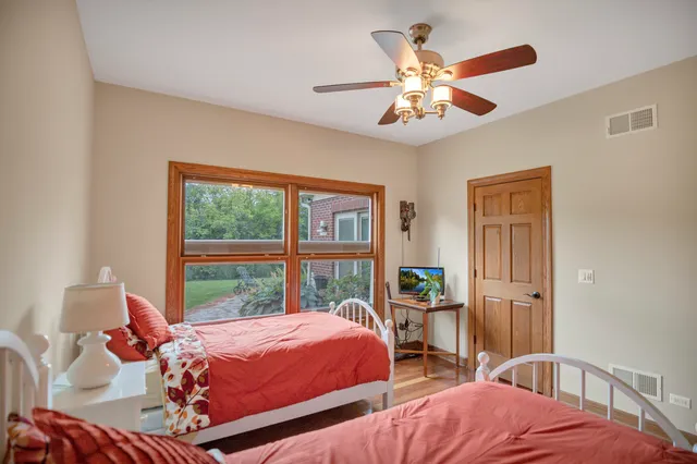 a spacious bedroom with a bed and a fireplace