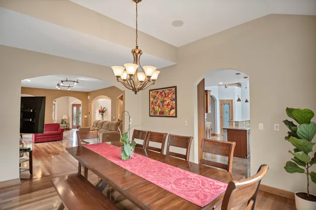 a kitchen with a sink and chairs