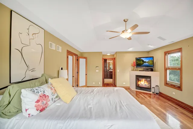 a view of a big room with windows and chandelier fan