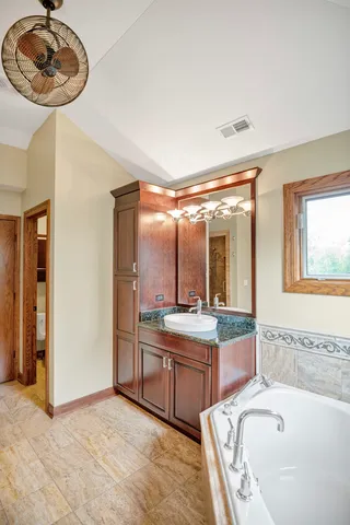 a view of a hallway with wooden floor and cabinet