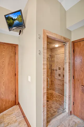 a room with lots of wooden furniture and a potted plant