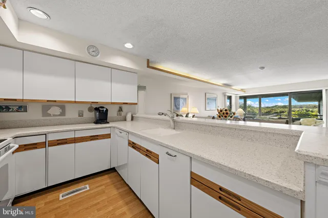 a kitchen with stainless steel appliances granite countertop a sink and cabinets