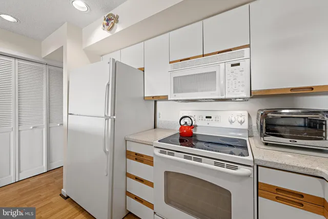 a kitchen with cabinets and stainless steel appliances
