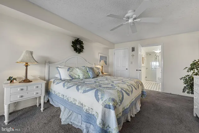 a spacious bedroom with a bed and a chandelier
