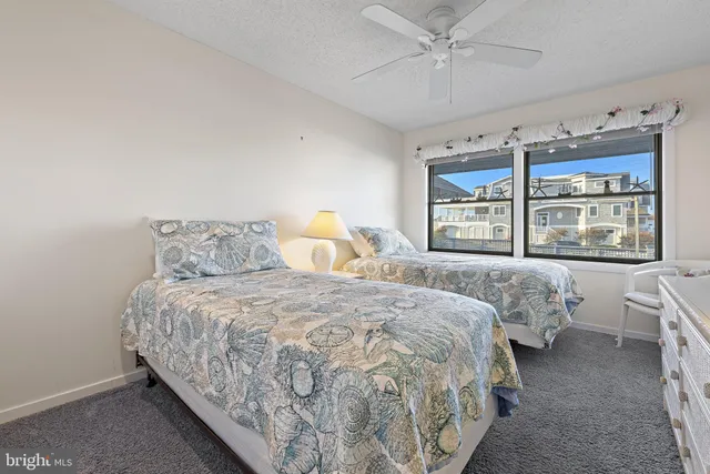 a spacious bedroom with a large bed and a dresser