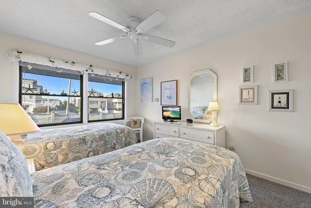 a bedroom with two beds and a chandelier