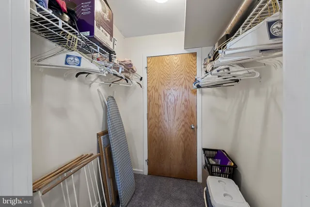 a view of a hallway with storage