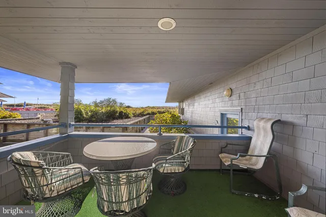 a dining room with furniture and a floor to ceiling window