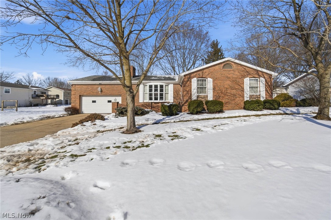 687 Lockwood Road Barberton, OH 44203 - Photo 1 of 2 View of front of house with brick siding and an attached garage