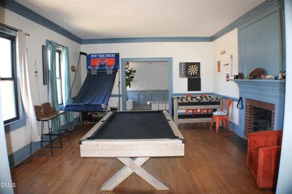 a living room with furniture and a view of kitchen