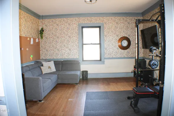 a view of a room with wooden floor and windows