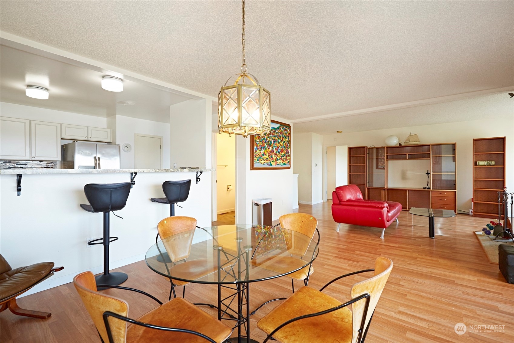6902 Southeast Riverside Drive, Unit 4 Vancouver, WA 98664 - Photo 11 of 25 a view of a dining room with furniture a chandelier and wooden floor