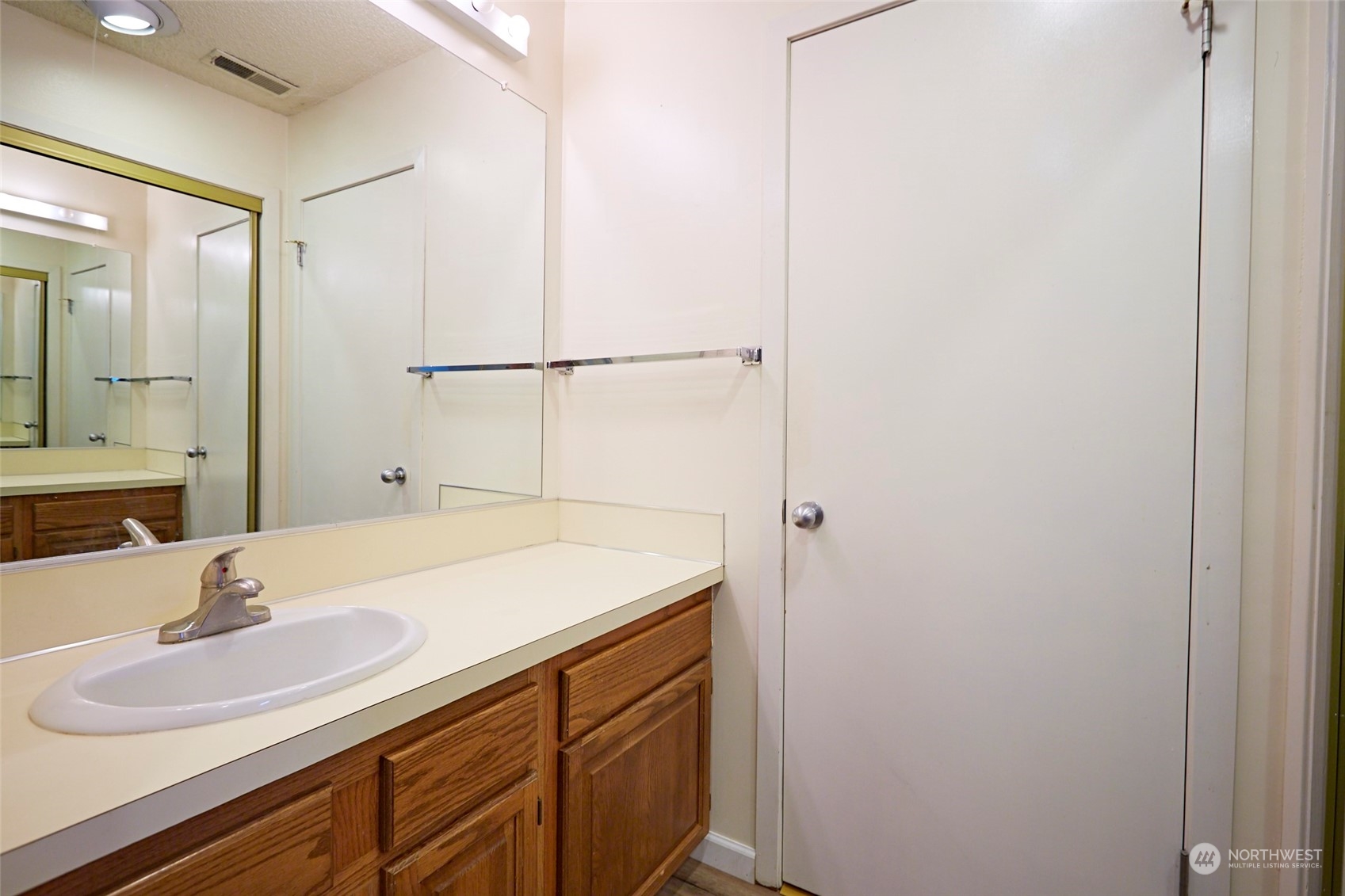6902 Southeast Riverside Drive, Unit 4 Vancouver, WA 98664 - Photo 6 of 25 a bathroom with a sink and a mirror