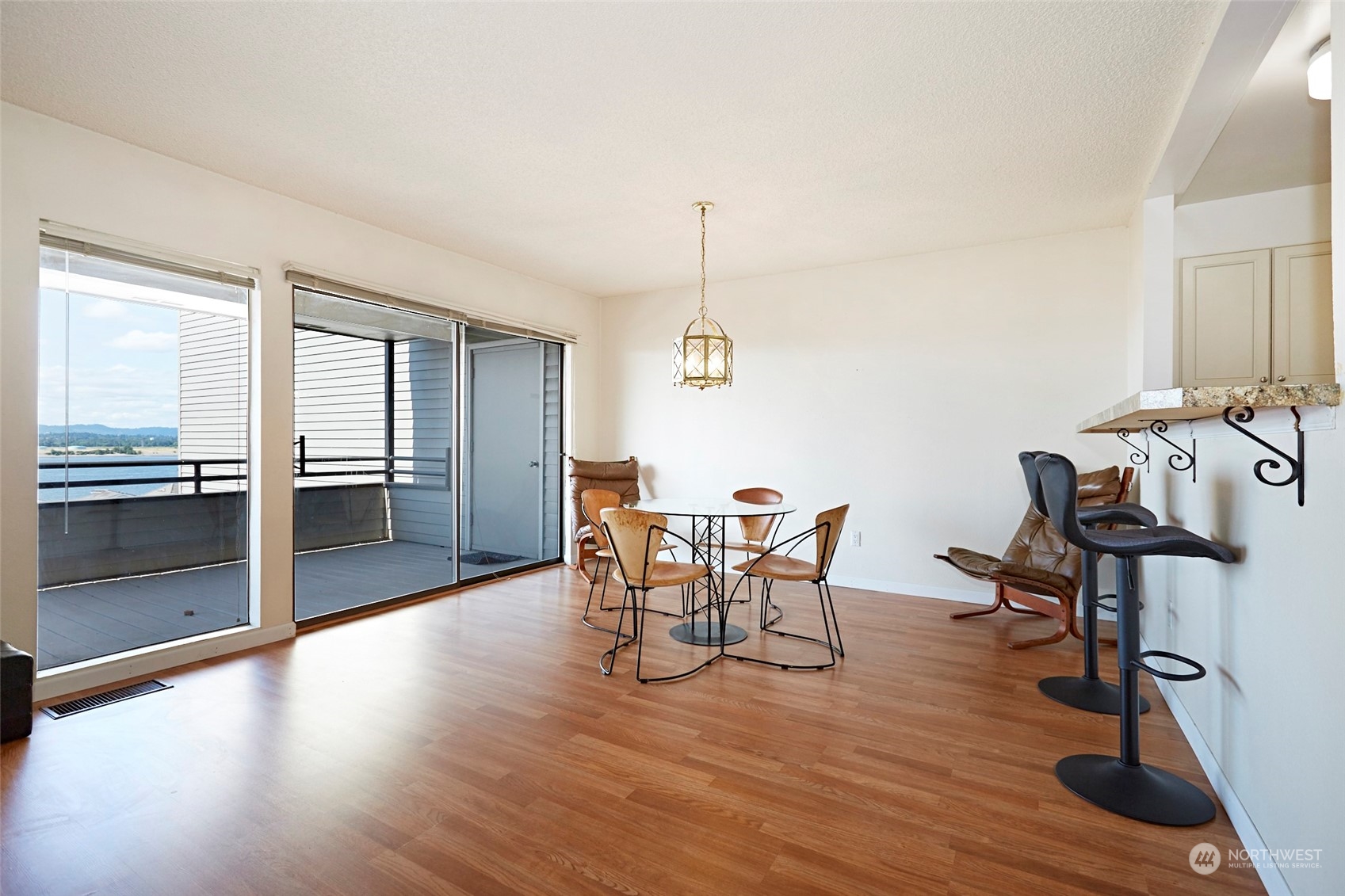 6902 Southeast Riverside Drive, Unit 4 Vancouver, WA 98664 - Photo 9 of 25 a view of a dining room with furniture window and wooden floor