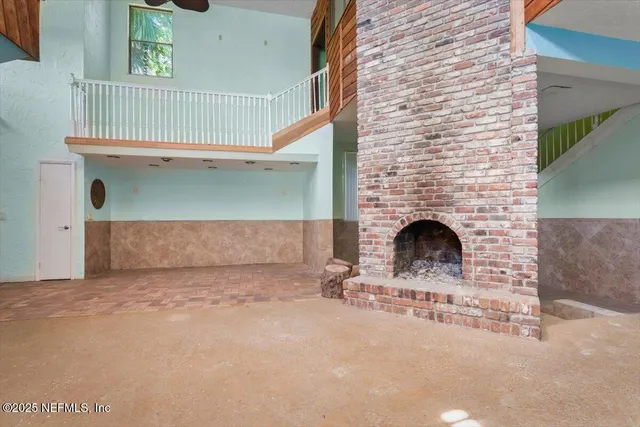 a spacious bedroom with a bed and a chandelier