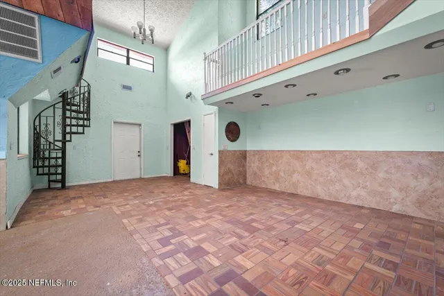 a view of a livingroom with a ceiling fan and window