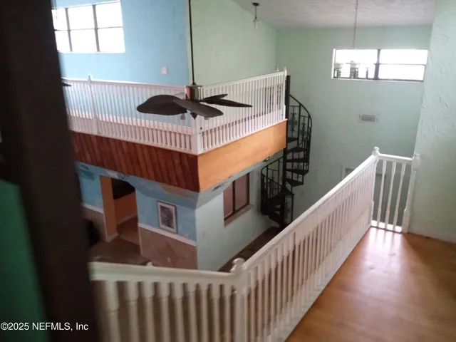 an aerial view of residential house with outdoor space and trees all around
