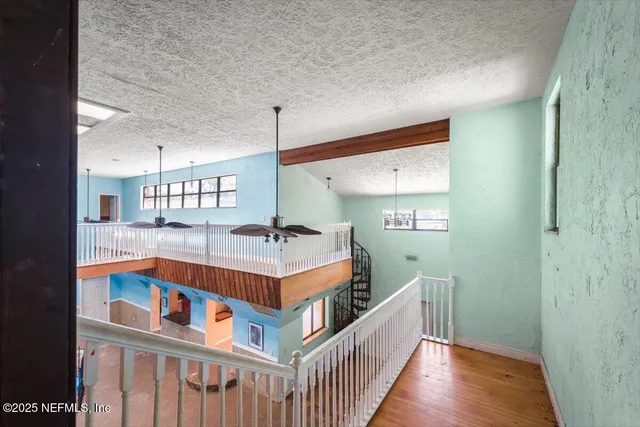 an aerial view of residential houses with outdoor space and trees