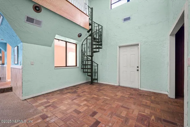 an aerial view of residential houses with outdoor space and trees