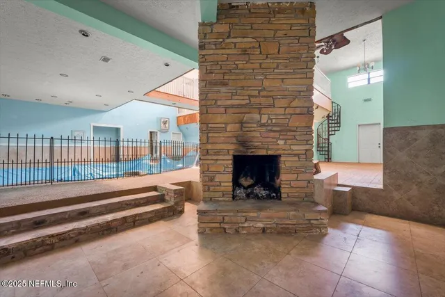 an aerial view of residential houses with outdoor space and trees