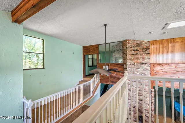 a view of a hallway with entryway and hall