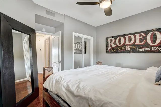 a bedroom with a large bed and a chandelier