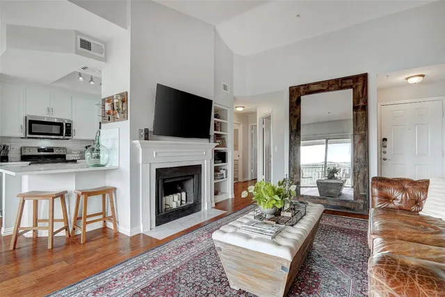 a living room with furniture a fireplace and a flat screen tv