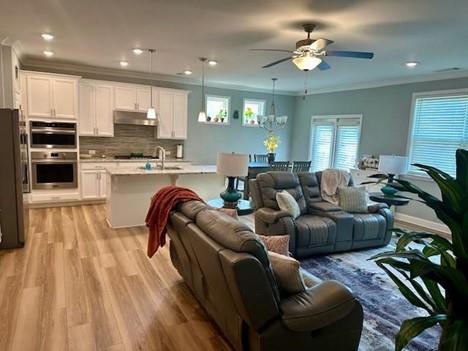 513 Forest Lane Canton, GA 30114 - Photo 18 of 78 a living room with furniture kitchen view and a wooden floor
