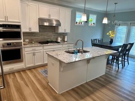 513 Forest Lane Canton, GA 30114 - Photo 21 of 78 a kitchen with a sink a microwave and cabinets