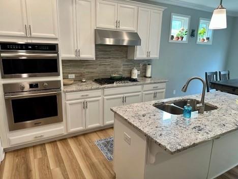 513 Forest Lane Canton, GA 30114 - Photo 24 of 78 a kitchen with a sink stove and cabinets