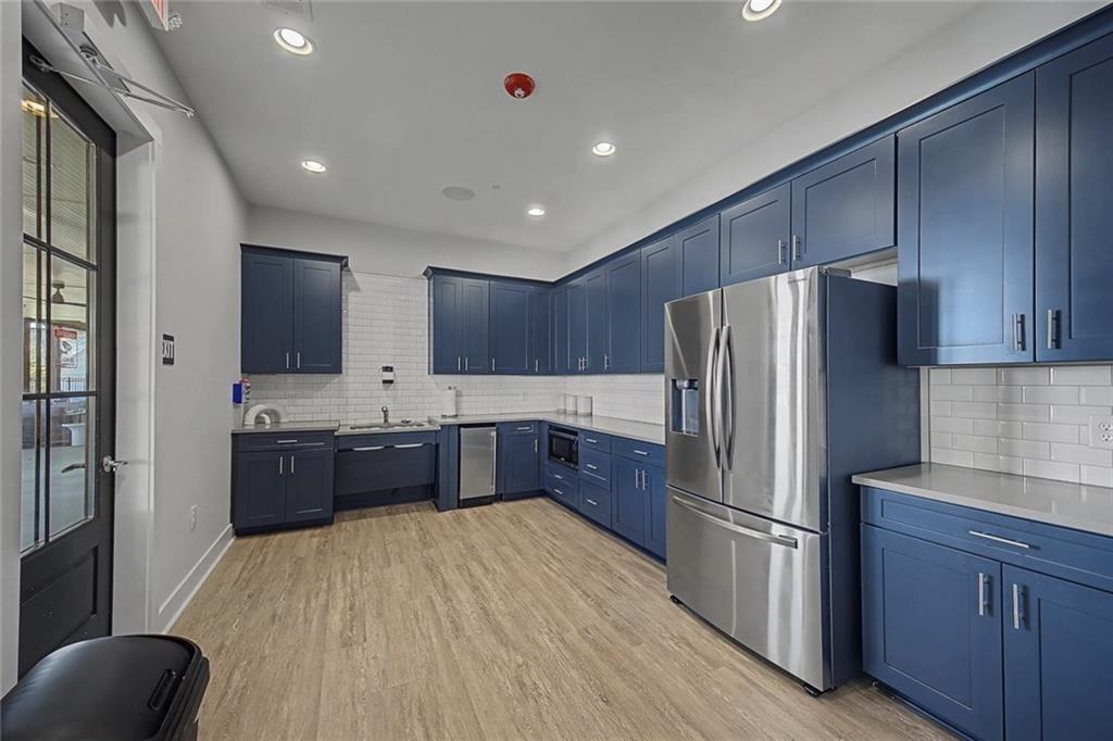 513 Forest Lane Canton, GA 30114 - Photo 67 of 78 a large kitchen with stainless steel appliances a refrigerator a sink dishwasher a oven with wooden cabinets and floor