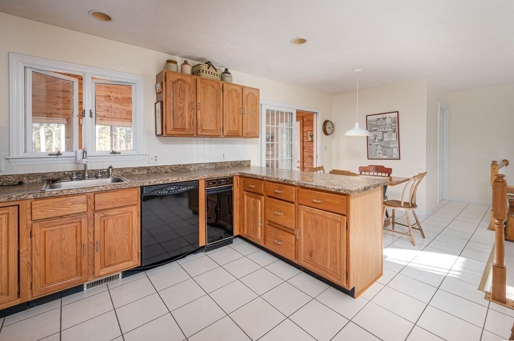 4 Camelot Circle Dudley, MA 01571 - Photo 16 of 42 a kitchen with stainless steel appliances granite countertop a stove sink and cabinets