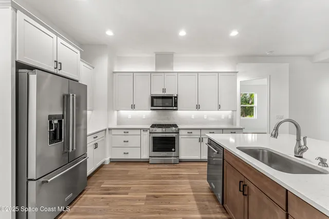 a kitchen with a sink stove and refrigerator