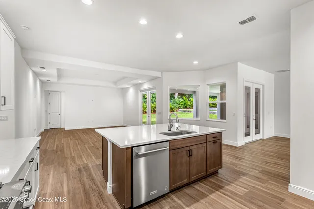 a kitchen with sink stove and refrigerator