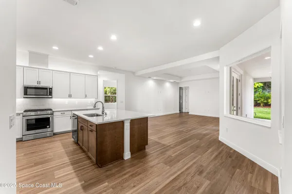 a large kitchen with stainless steel appliances granite countertop a stove and a sink