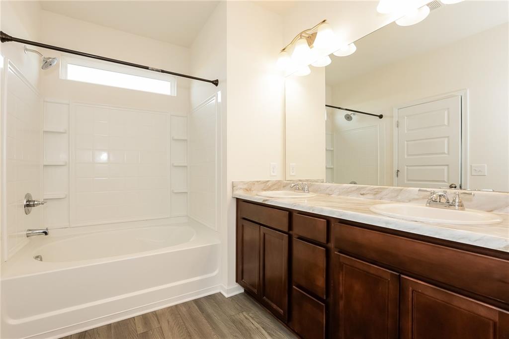 36 Felton Walk Boulevard Cartersville, GA 30120 - Photo 12 of 15 a bathroom with a granite countertop sink mirror and a bathtub