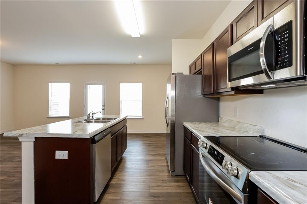 36 Felton Walk Boulevard Cartersville, GA 30120 - Photo 8 of 15 a kitchen with stainless steel appliances granite countertop a sink a stove and a wooden floors