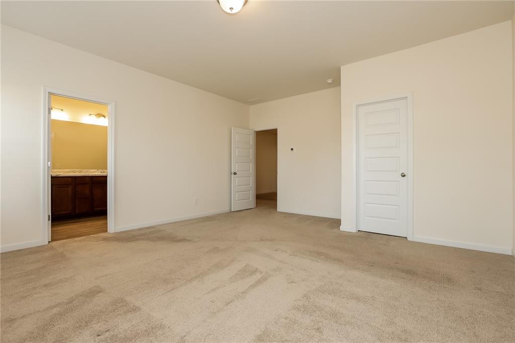 36 Felton Walk Boulevard Cartersville, GA 30120 - Photo 9 of 15 an empty room with closet and mirror