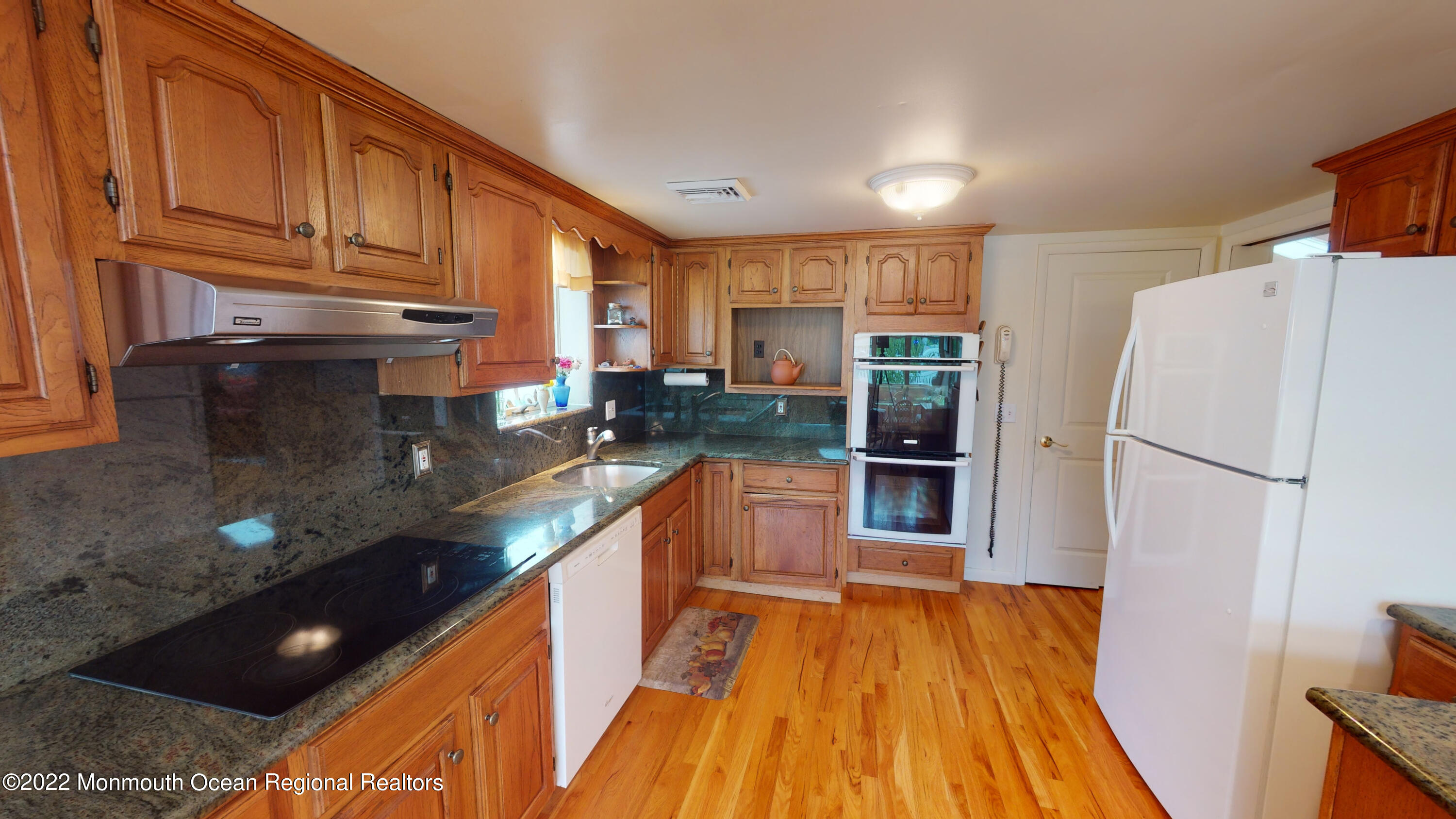 2 Funston Road Lavallette, NJ 08735 - Photo 9 of 24 a kitchen with stainless steel appliances granite countertop a refrigerator a stove and a sink with wooden floors