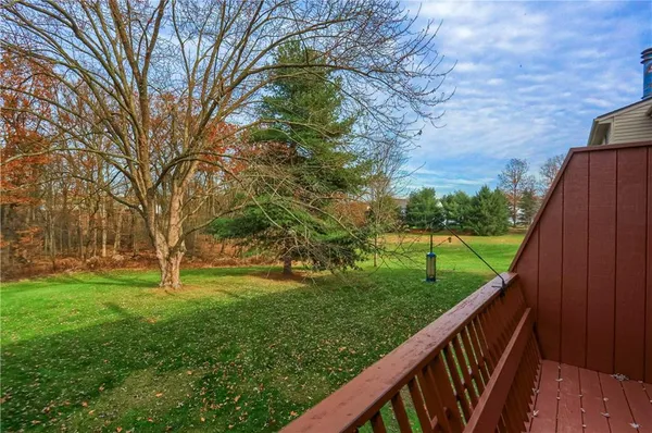 a view of a house with a wooden deck