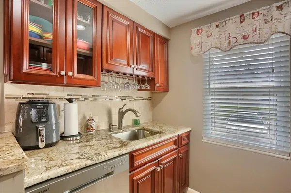 a kitchen with granite countertop cabinets and sink