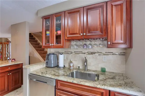 a kitchen with stainless steel appliances granite countertop a stove microwave and refrigerator